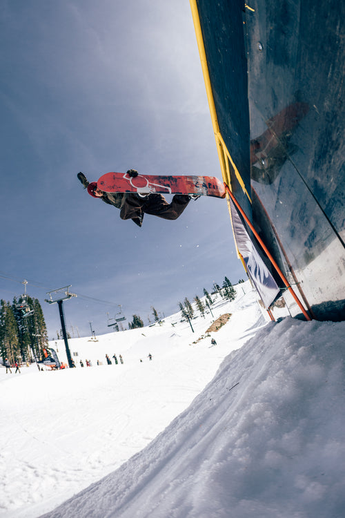 Mike Rav riding a CAPiTA Ultrafear above a park wall; photo by Neil DaCosta