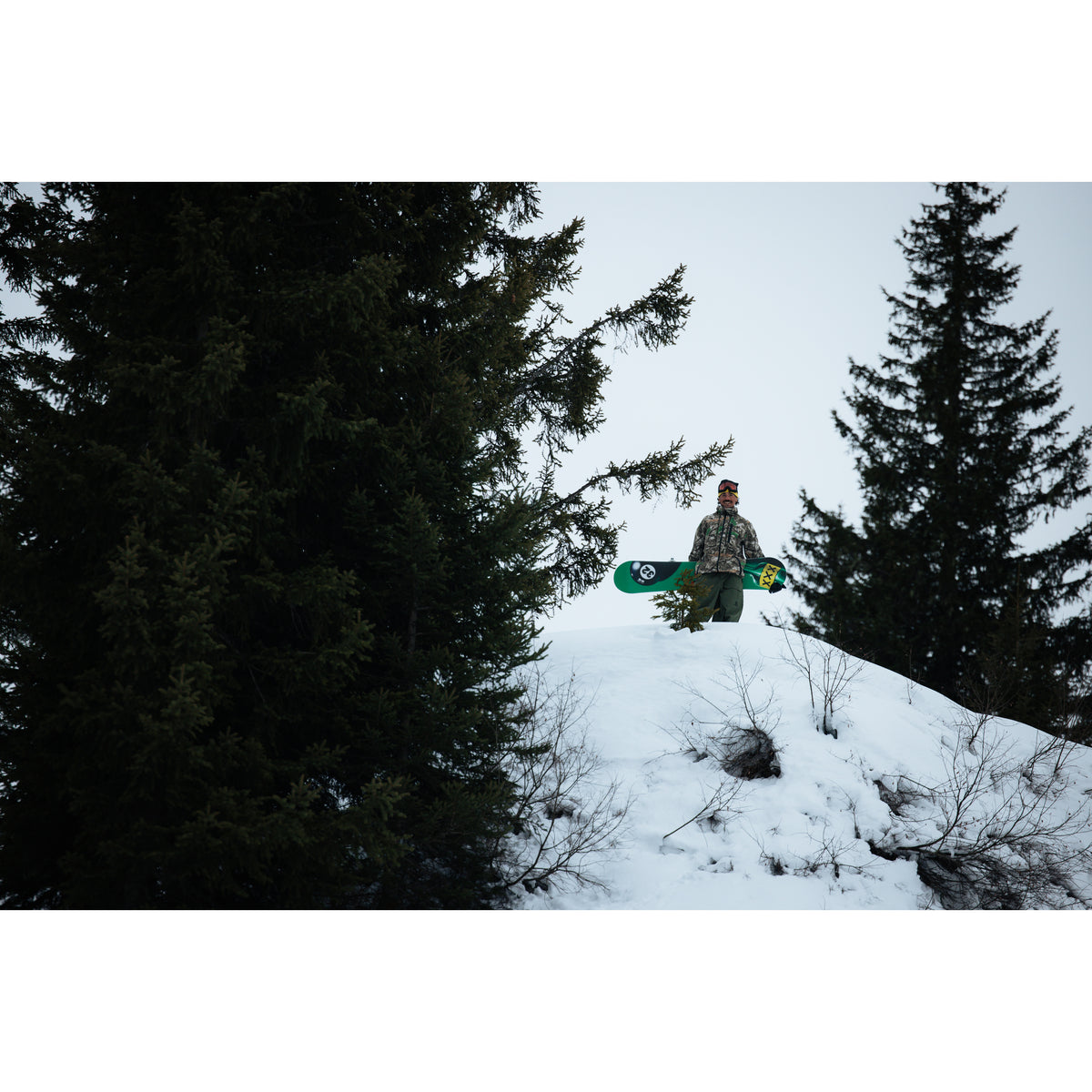 Rider jumping the XXX Fava Pro snowboard in snowy terrain